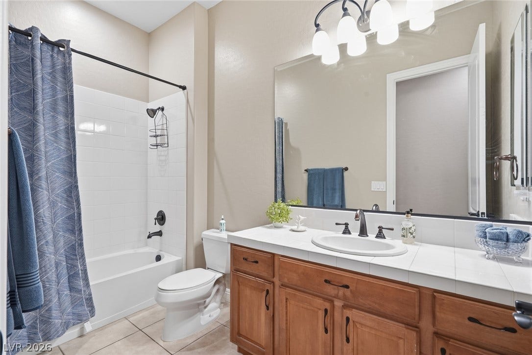 2397 Luberon Drive, Henderson, NV 89044 A well-lit bathroom features a vanity with ample storage and a tub/shower combination.