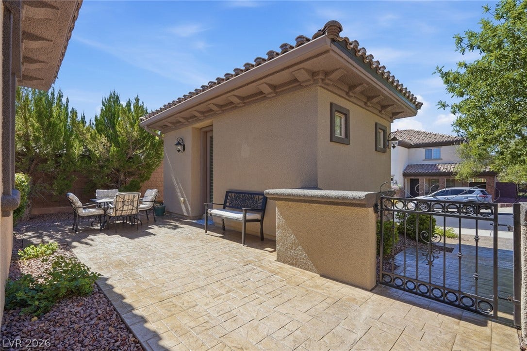 2397 Luberon Drive, Henderson, NV 89044 An inviting courtyard with patterned hardscaping and lush greenery, perfect for outdoor gatherings.