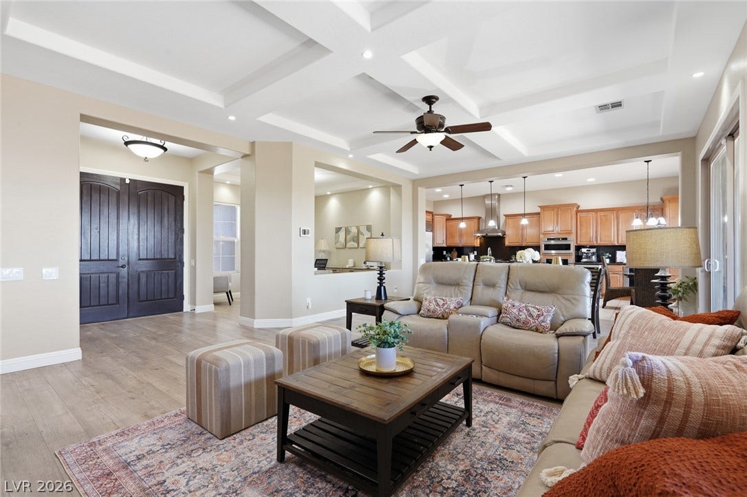 2397 Luberon Drive, Henderson, NV 89044 Enter into an open-concept living area, where coffered ceilings and wood flooring create a grand, inviting atmosphere.