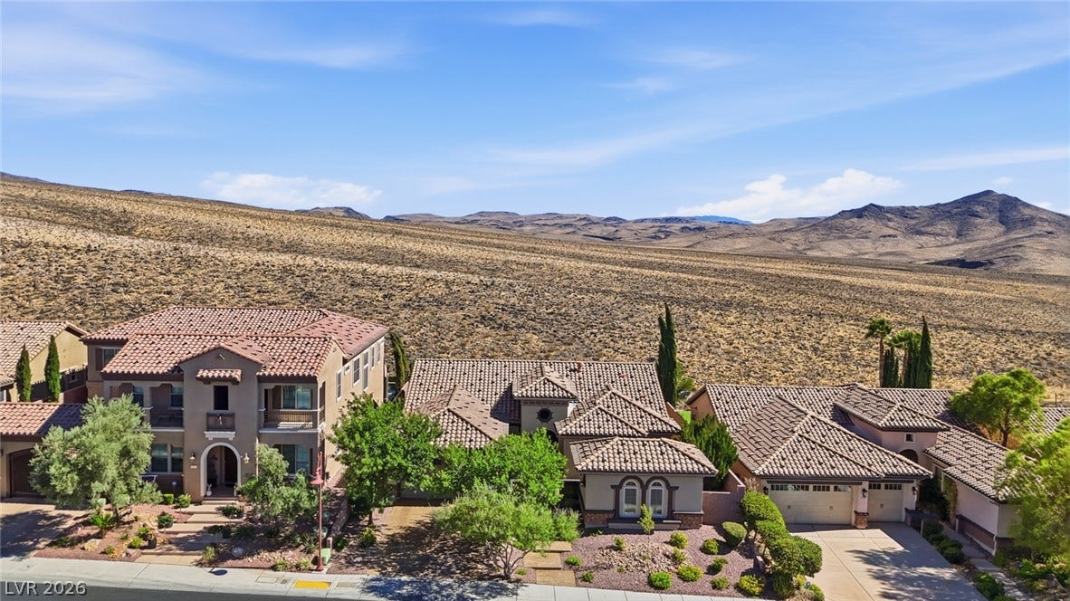 2397 Luberon Drive, Henderson, NV 89044 Perched on a serene desert landscape, this home offers tranquil views and an inviting curb appeal.