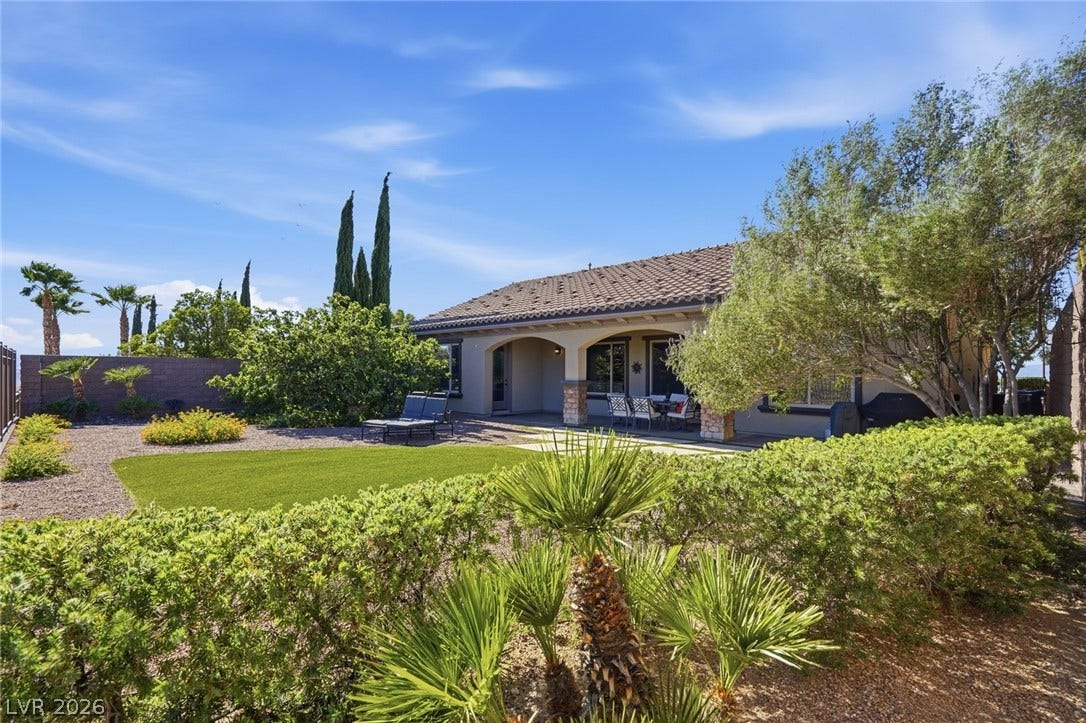 2397 Luberon Drive, Henderson, NV 89044 A private, landscaped backyard offers a covered patio and ample space for relaxation.