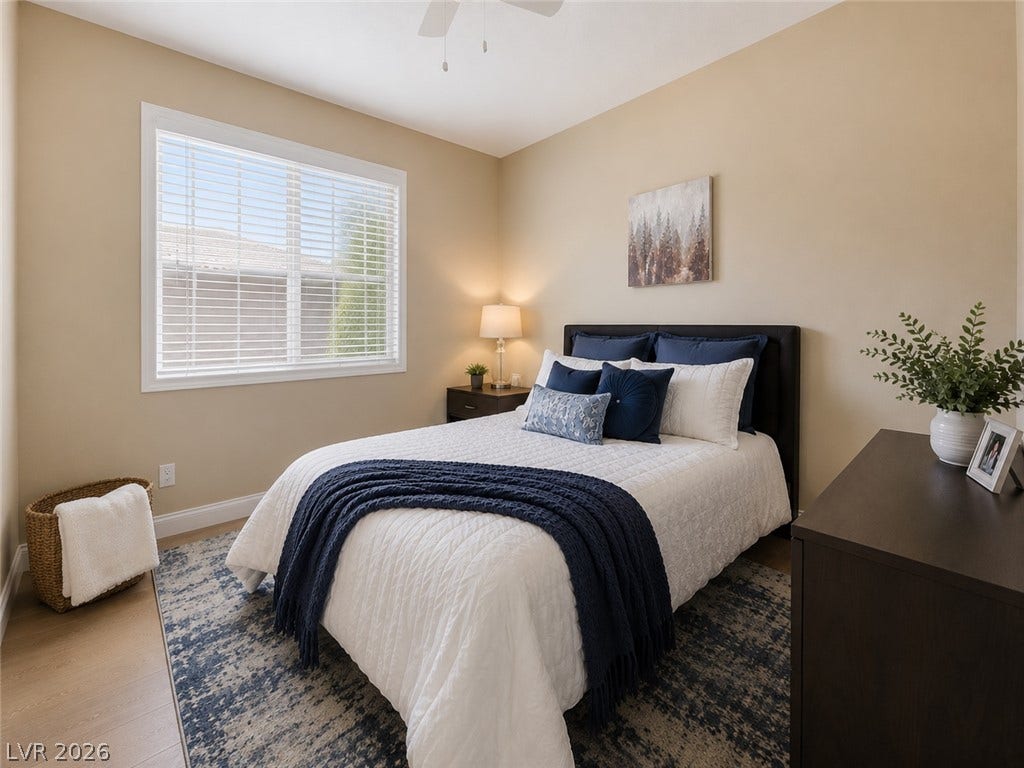 2397 Luberon Drive, Henderson, NV 89044 A well-lit bedroom with natural light and hardwood floors invites serene relaxation.