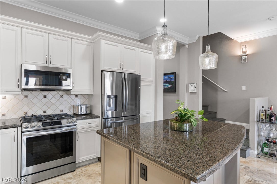 6 VIA VASARI, #102, Henderson, NV 89011 A well-appointed culinary space featuring sleek stainless steel appliances and generous counter seating.