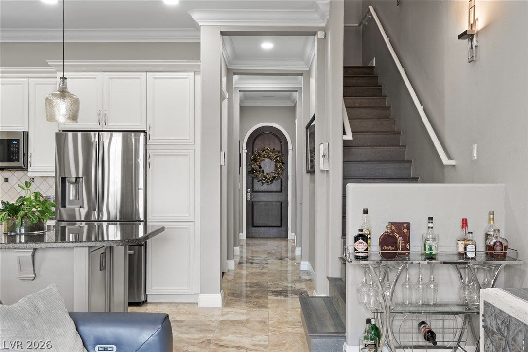 6 VIA VASARI, #102, Henderson, NV 89011 A striking arched entryway and elegant staircase define this home's inviting interior.