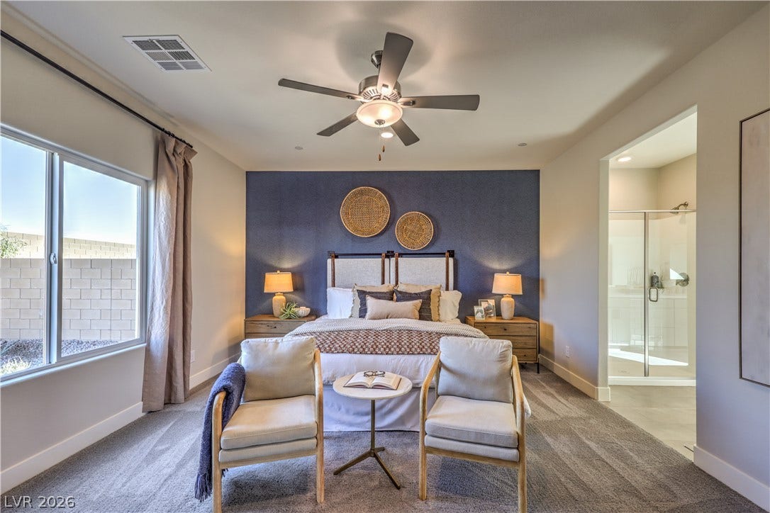 An inviting bedroom with plush carpeting, offering a private entrance to an en-suite bathroom.