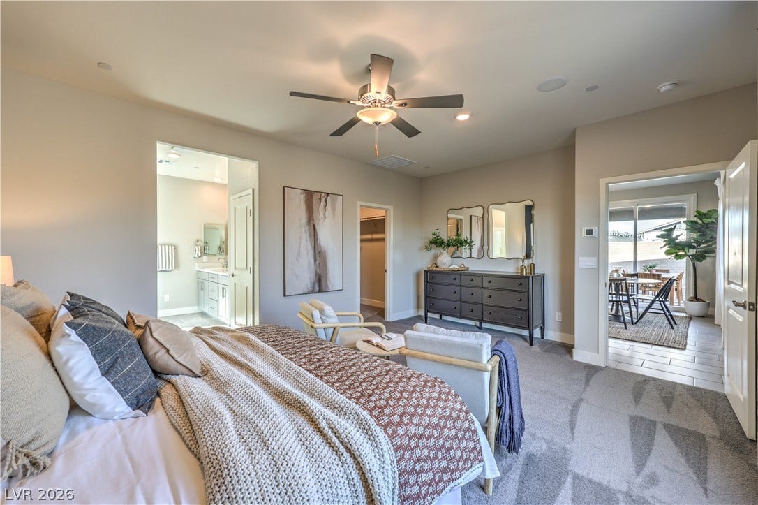 A tranquil primary bedroom with direct access to an adjacent bath, featuring recessed lighting and a ceiling fan for comfort.