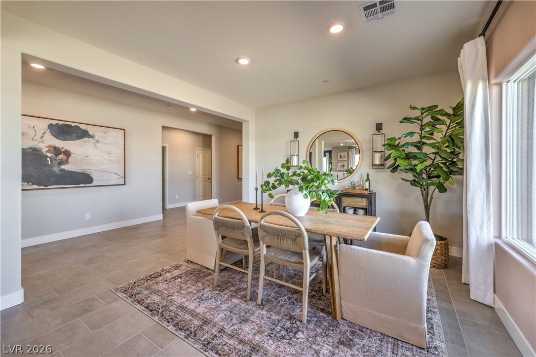 Recessed lighting illuminates this inviting dining area, perfect for entertaining.