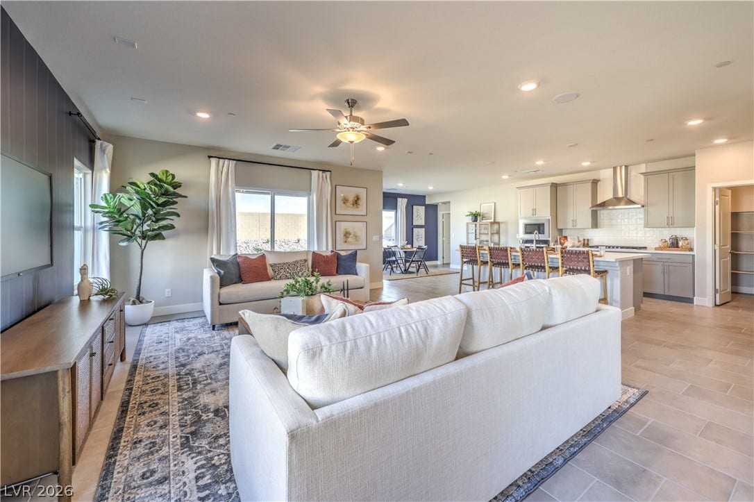 An open concept living area connects seamlessly with the kitchen and dining space, perfect for modern living.