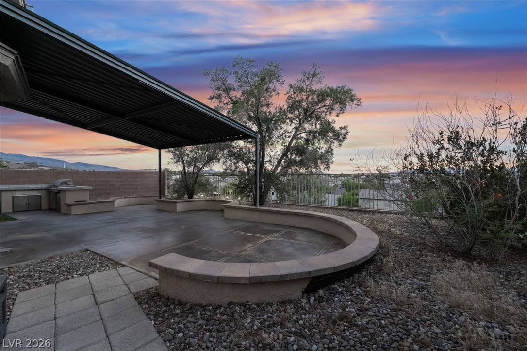 2439 Kaymin Ridge Road, Henderson, NV 89052 An inviting covered patio offers ample space for entertaining with a built-in barbecue and scenic views.
