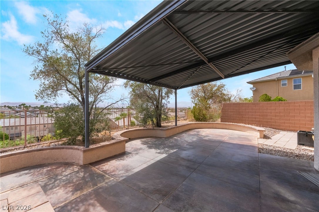 2439 Kaymin Ridge Road, Henderson, NV 89052 A spacious covered patio provides an ideal setting for outdoor gatherings and relaxation.