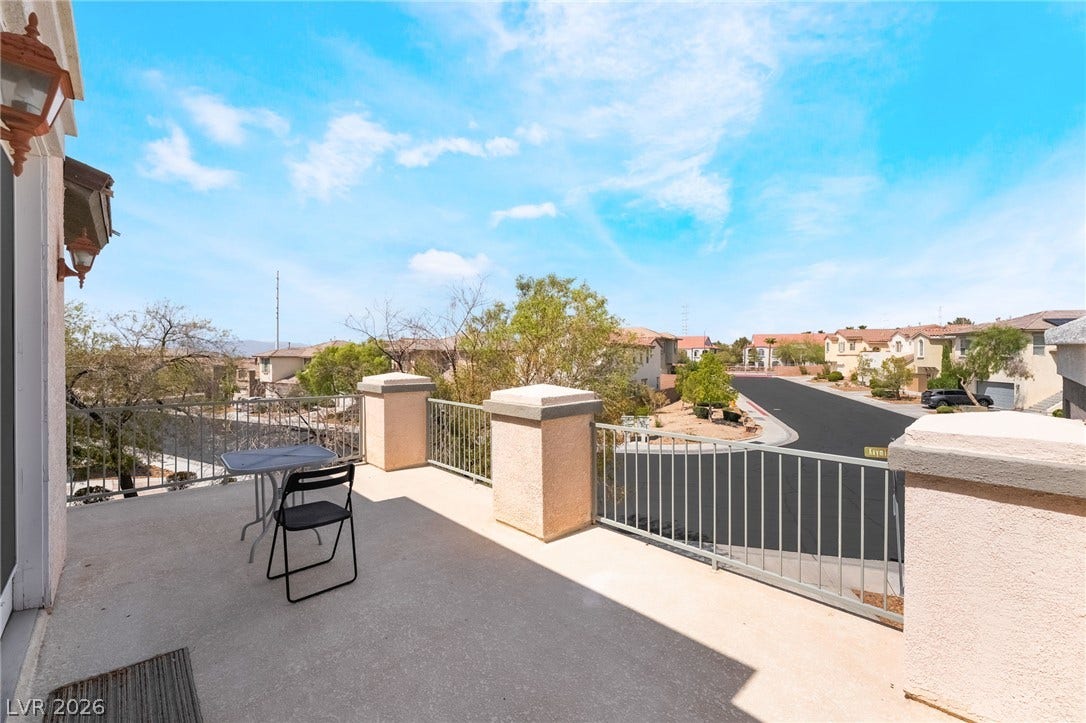 2439 Kaymin Ridge Road, Henderson, NV 89052 A spacious balcony offers elevated neighborhood views under a clear, open sky.