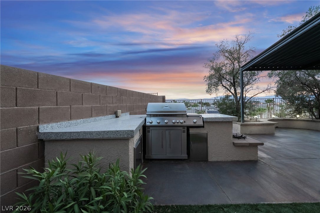2439 Kaymin Ridge Road, Henderson, NV 89052 An outdoor grilling station with a built-in barbecue and generous counter space awaits your culinary creations.