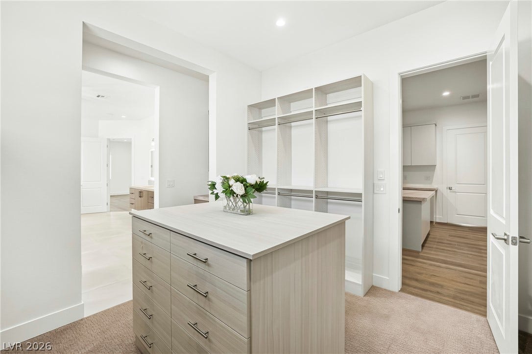 4360 Conough Lane, Las Vegas, NV 89129 A well-organized walk-in closet offers ample storage with built-in shelving and a central dresser island.