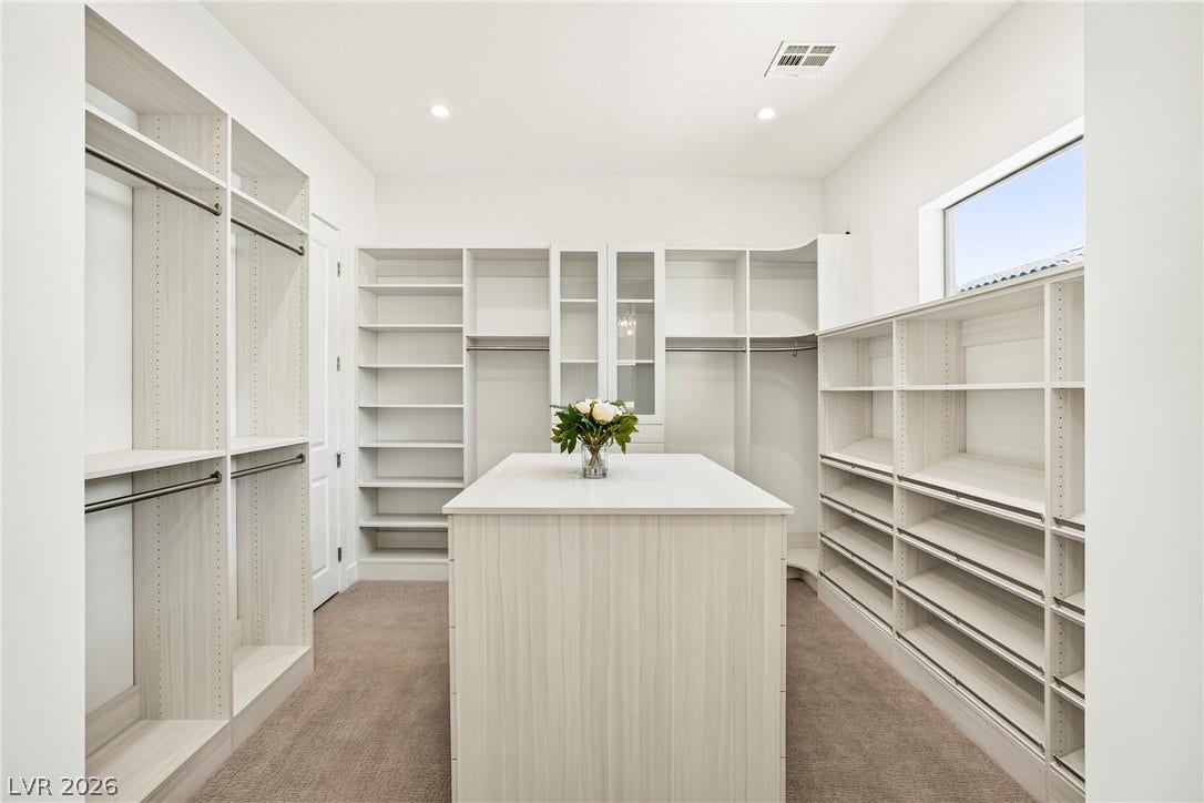 4360 Conough Lane, Las Vegas, NV 89129 Ample built-in shelving and hanging space defines this generously proportioned dressing area with an organizing island.