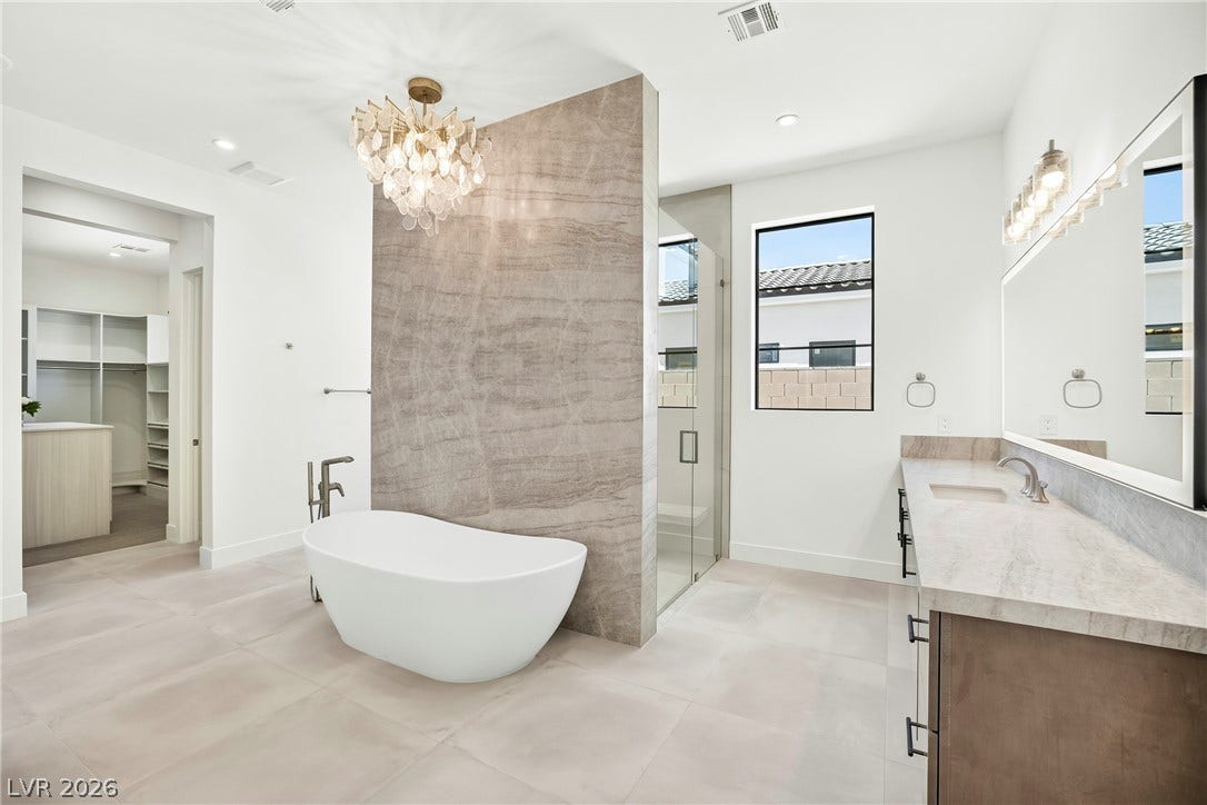 4360 Conough Lane, Las Vegas, NV 89129 A refined bathroom featuring a free-standing tub, a spacious shower, and a large vanity with ample counter space.