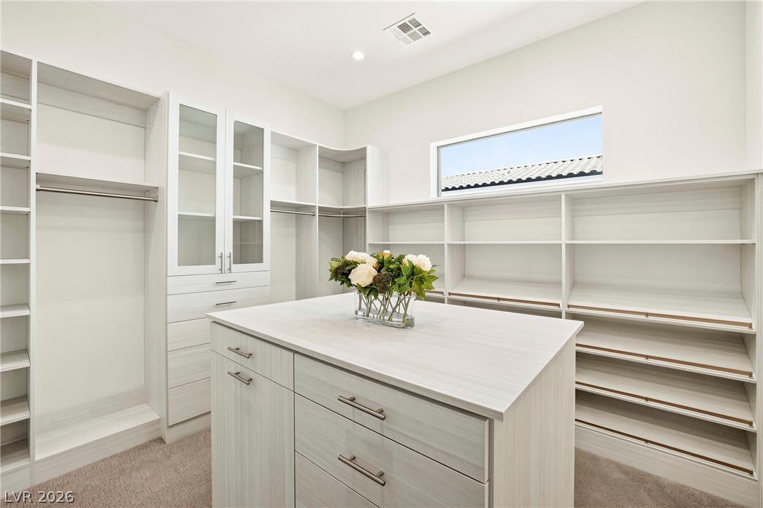 4360 Conough Lane, Las Vegas, NV 89129 An organized walk-in closet features ample shelving, hanging space, and a central island for optimal storage.