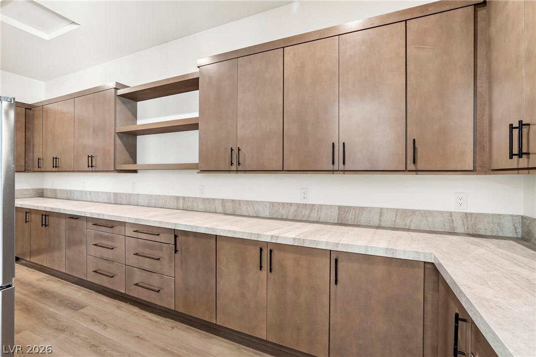 4360 Conough Lane, Las Vegas, NV 89129 Functional cabinetry and generous counter space create an organized and efficient kitchen or utility area.
