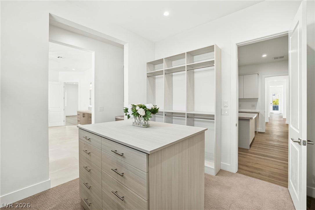 4360 Conough Lane, Las Vegas, NV 89129 Ample storage solutions abound in this well-appointed closet, featuring built-in shelving and a central drawer island.