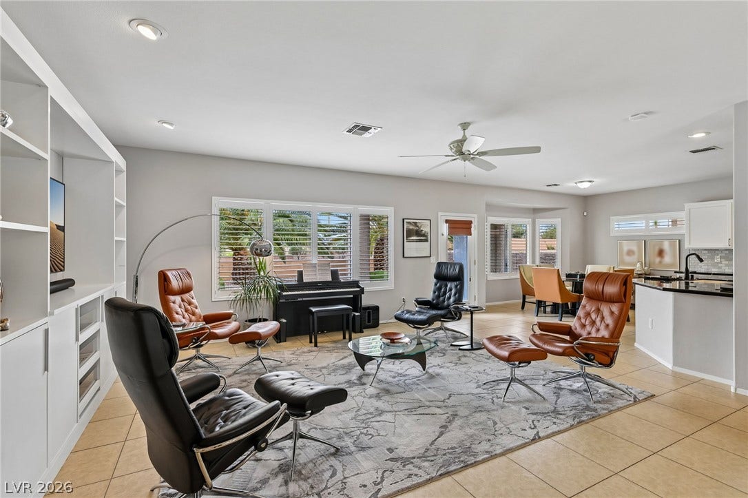 2141 Colvin Run Drive, Henderson, NV 89052 An inviting great room with ample natural light offers spacious living and dining areas, complemented by built-in shelving.