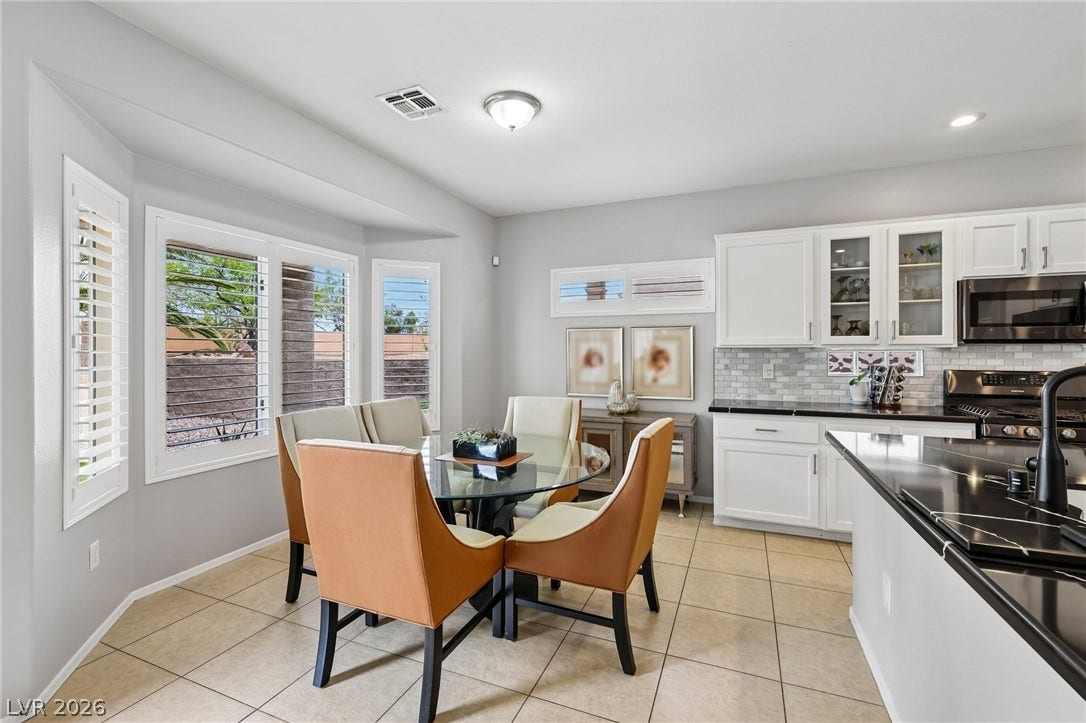 2141 Colvin Run Drive, Henderson, NV 89052 A well-appointed kitchen and dining area features sleek countertops, stylish cabinetry, and plantation shutters.