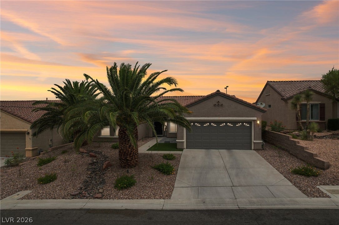 2141 Colvin Run Drive, Henderson, NV 89052 Sunset at the residence presents desert-friendly landscaping and an inviting entry, bathed in the soft glow of a twilight sky.