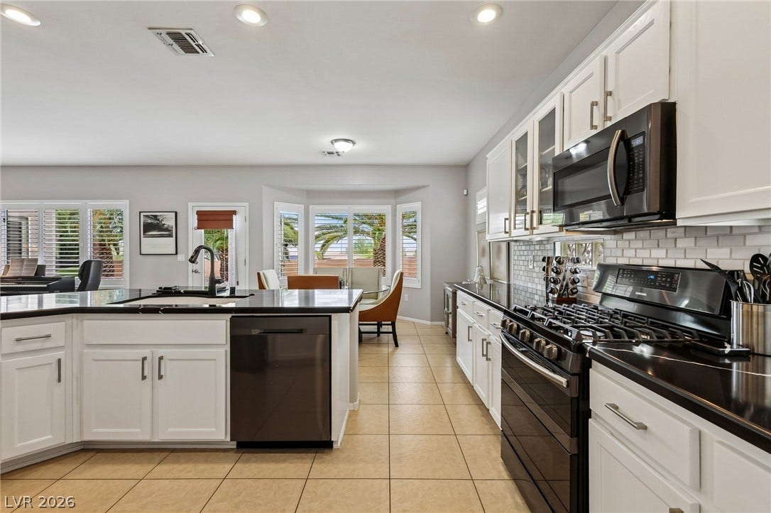2141 Colvin Run Drive, Henderson, NV 89052 Culinary aspirations find their home in this well-appointed kitchen featuring a bay window breakfast nook and abundant counter space.