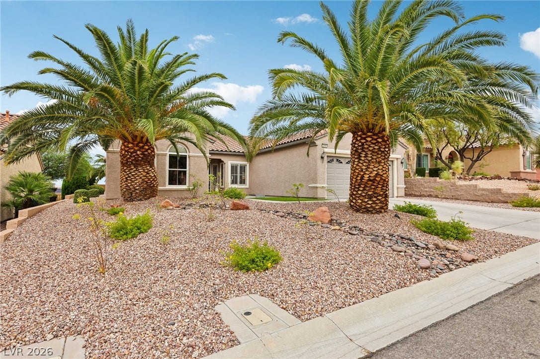 2141 Colvin Run Drive, Henderson, NV 89052 Two towering palm trees frame this desert-landscaped home with an attached garage.