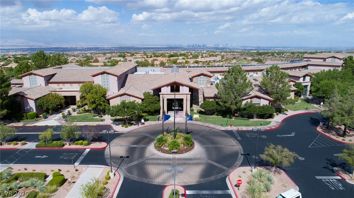 2141 Colvin Run Drive, Henderson, NV 89052 The inviting entrance features a circular driveway leading to Sun City Anthem's Main Clubhouse "Anthem Center" -- surrounded by mature trees and verdant landscaping.