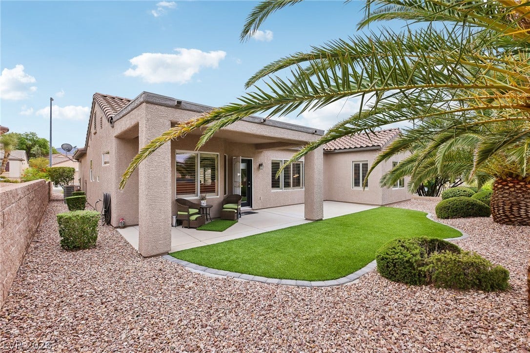 2141 Colvin Run Drive, Henderson, NV 89052 A private backyard oasis features a covered patio, artificial turf, and a low-maintenance landscape.