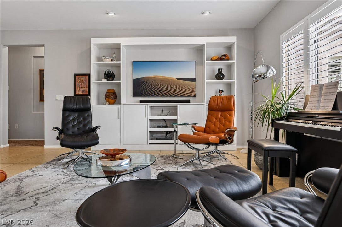 2141 Colvin Run Drive, Henderson, NV 89052 A refined living area boasts a built-in media center, perfectly blending modern aesthetics with functional design.