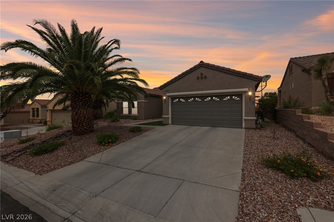 2141 Colvin Run Drive, Henderson, NV 89052 An inviting exterior with a desert-friendly landscape and a paved driveway under a painted sky.