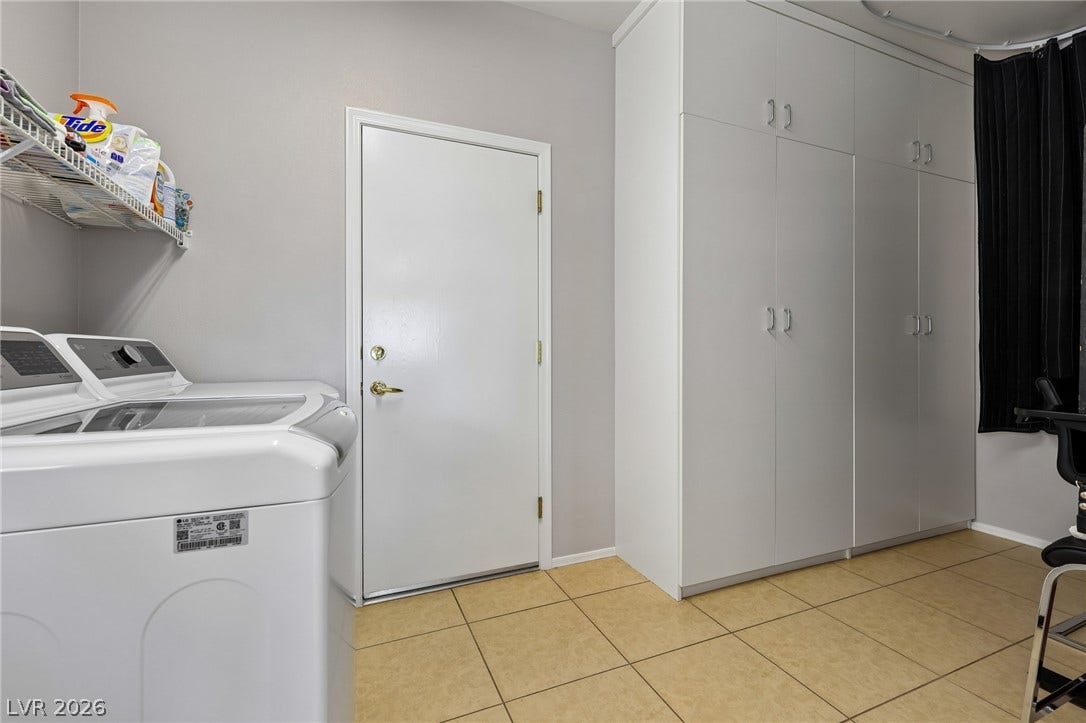 2141 Colvin Run Drive, Henderson, NV 89052 Functional laundry space featuring modern appliances and ample storage cabinetry. The oversized laundry room is great for extra storage!