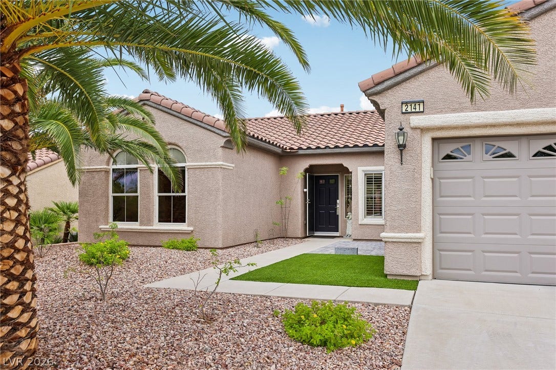 2141 Colvin Run Drive, Henderson, NV 89052 A desert-friendly landscape of gravel and palm trees enhances this welcoming stucco home with a tile roof.