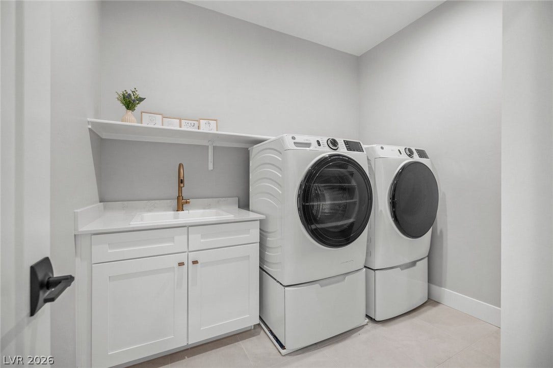 3194 Poplar Crest Court, Henderson, NV 89044 A well-appointed laundry area offers practical utility with modern appliances and a dedicated wash sink.