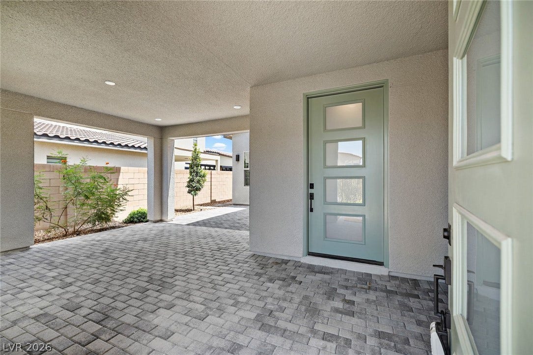 3194 Poplar Crest Court, Henderson, NV 89044 A welcoming entry featuring a covered patio with sophisticated paver flooring leads to a modern front door.