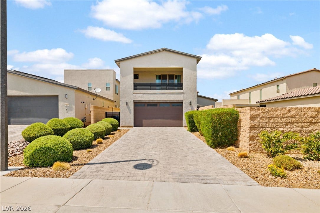 3194 Poplar Crest Court, Henderson, NV 89044 A contemporary residence boasts a paver driveway, well-maintained landscaping, and a second-story balcony.