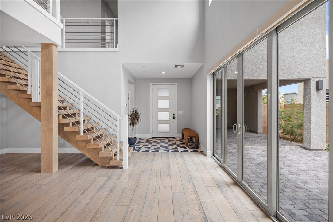 3194 Poplar Crest Court, Henderson, NV 89044 A grand entrance with an open staircase and wide plank wood flooring welcomes you inside.