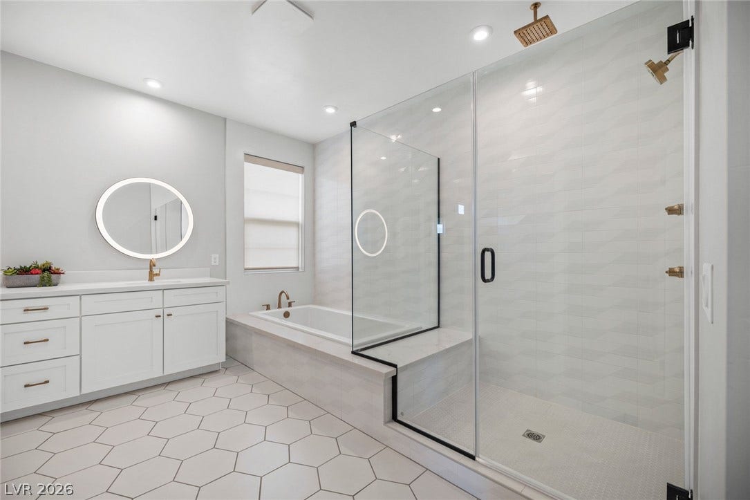3194 Poplar Crest Court, Henderson, NV 89044 Luxurious bathroom features a spacious walk-in shower, a built-in soaking tub, and a sleek vanity with a lighted mirror.