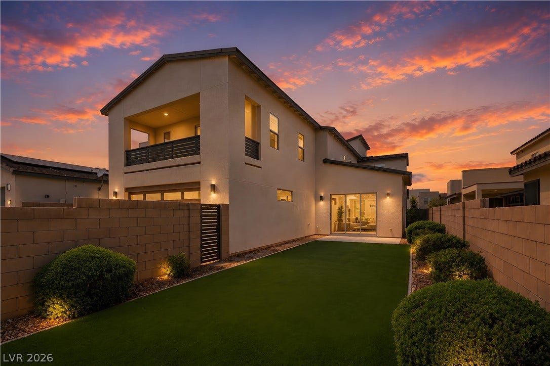 3194 Poplar Crest Court, Henderson, NV 89044 A manicured lawn spans the private backyard beneath a vibrant evening sky.