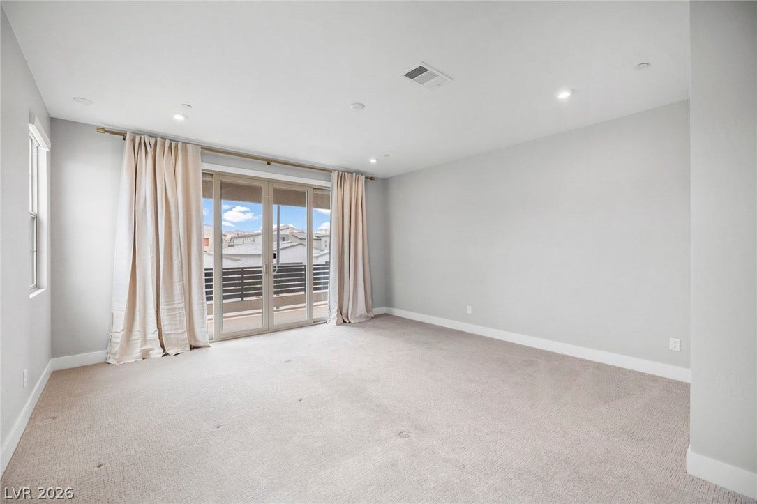 3194 Poplar Crest Court, Henderson, NV 89044 A quiet retreat with a sliding glass door offering balcony access, ideal for serene mornings.