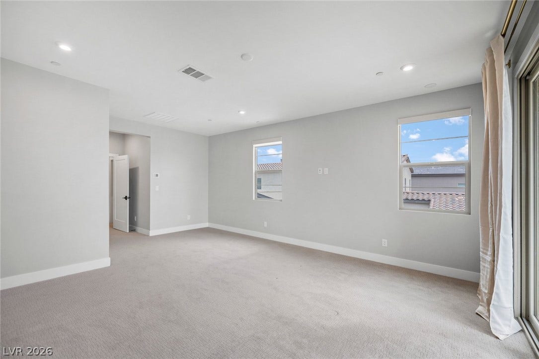 3194 Poplar Crest Court, Henderson, NV 89044 A spacious, naturally illuminated room features plush carpeting and elegant recessed lighting.