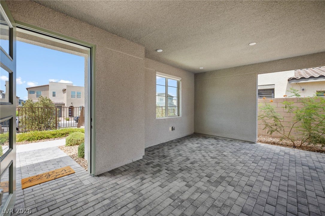 3194 Poplar Crest Court, Henderson, NV 89044 An inviting paver patio extends a warm welcome, offering a sheltered outdoor space.