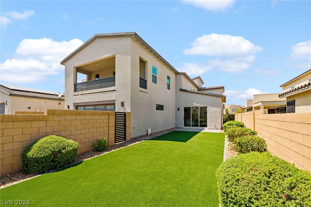 3194 Poplar Crest Court, Henderson, NV 89044 A private yard with lush artificial turf and mature landscaping creates a serene outdoor retreat.