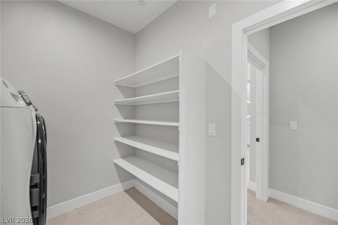 3194 Poplar Crest Court, Henderson, NV 89044 A dedicated utility space with organized shelving provides practical storage and laundry amenities.