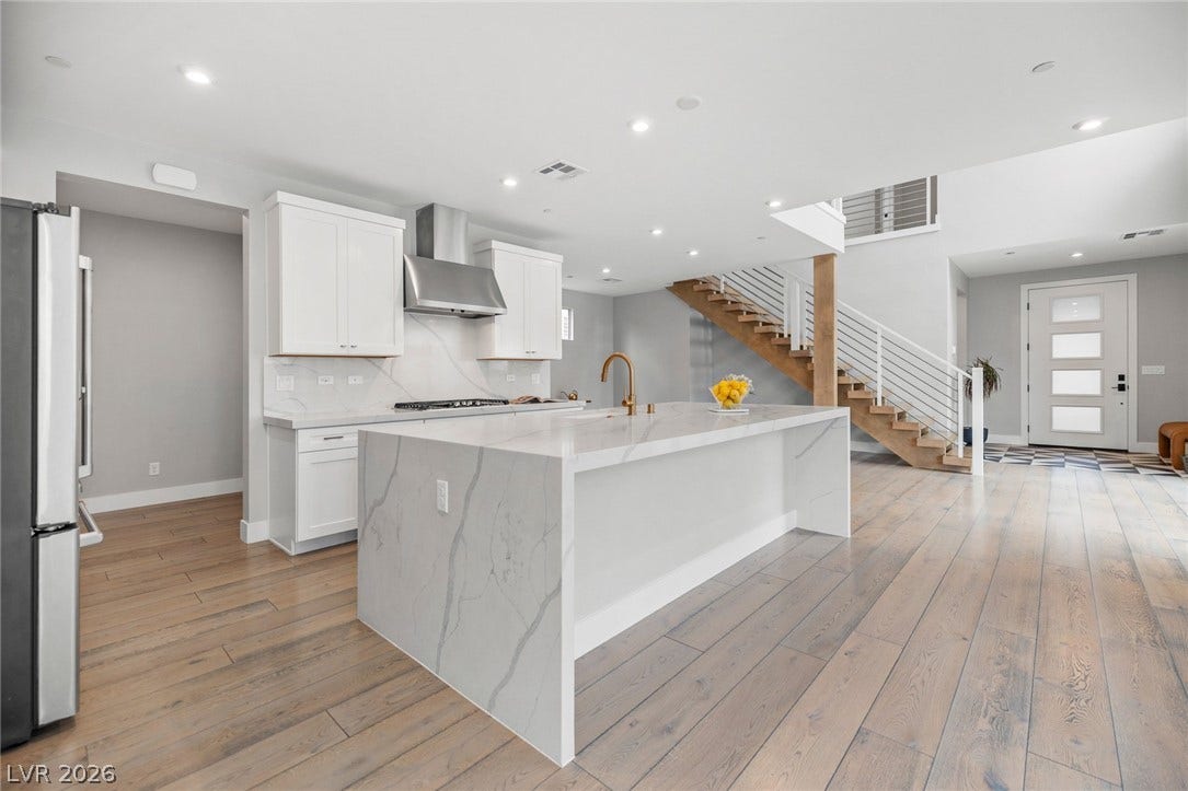 3194 Poplar Crest Court, Henderson, NV 89044 Culinary excellence awaits in this open-concept kitchen with a waterfall island, connecting effortlessly to the entry and staircase.