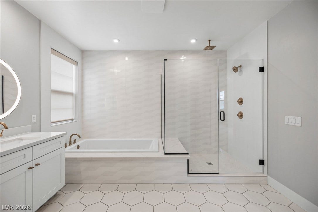 3194 Poplar Crest Court, Henderson, NV 89044 Luxurious bathroom retreat features a spacious soaking tub, walk-in shower, and double vanity.