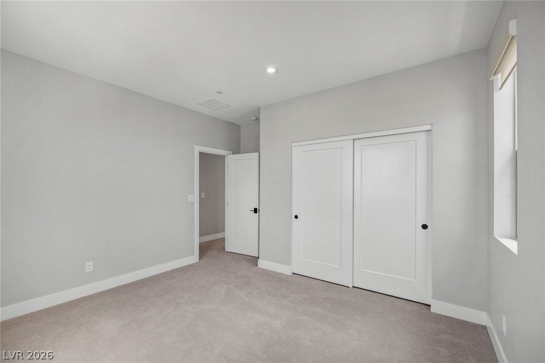 3194 Poplar Crest Court, Henderson, NV 89044 A well-lit bedroom with fresh carpeting and ample closet space.