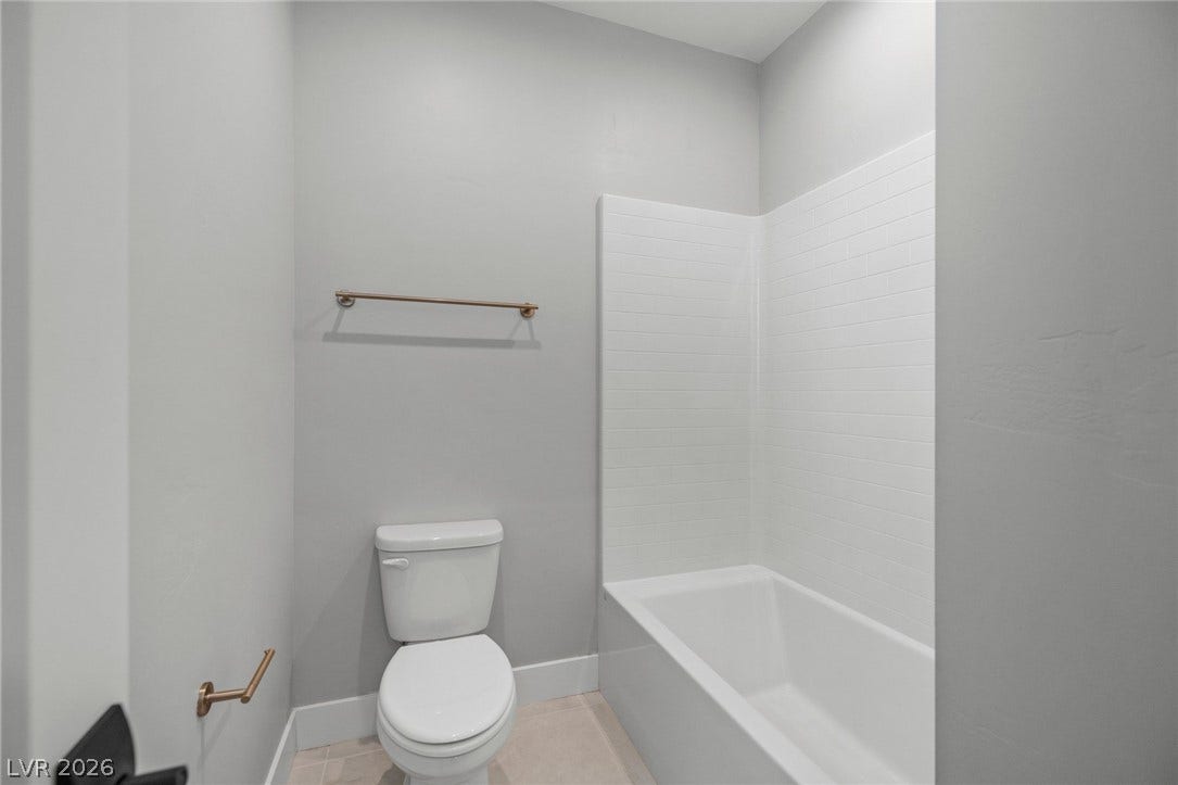 3194 Poplar Crest Court, Henderson, NV 89044 A well-appointed bath features a sleek tub and shower combination with clean tile work.