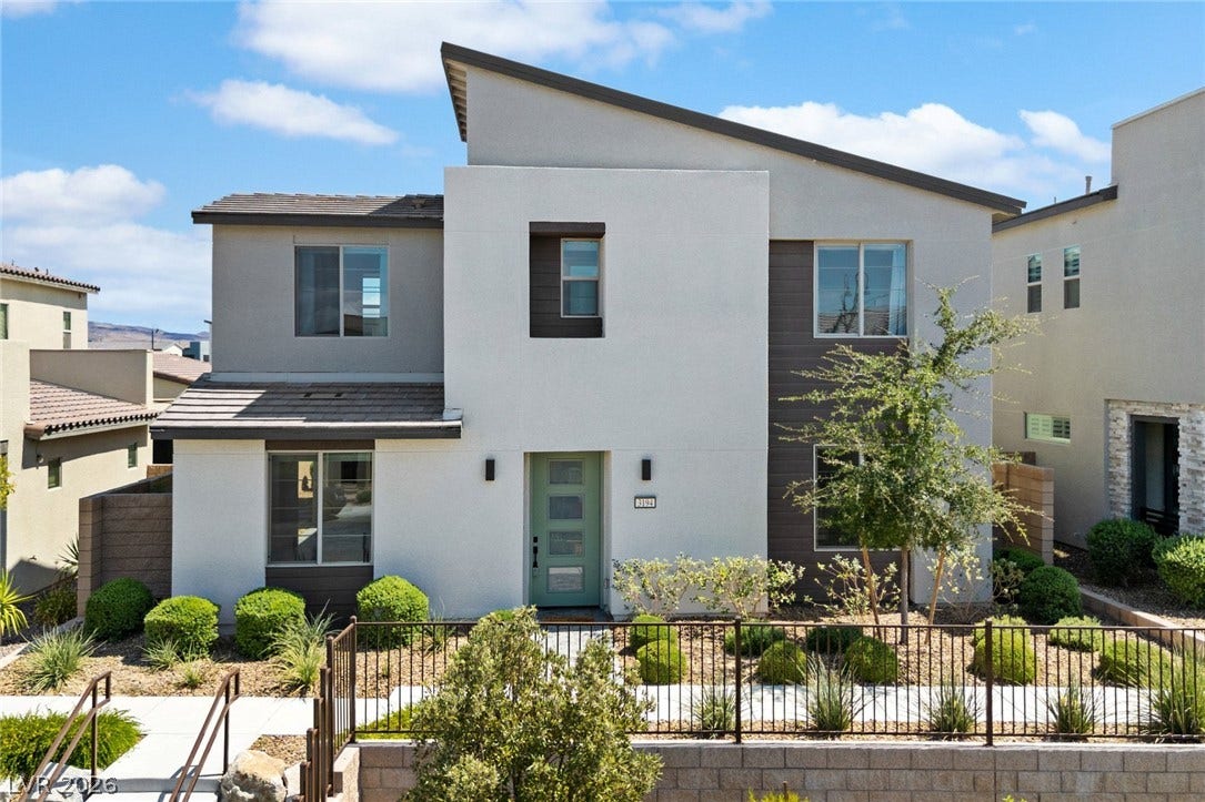 3194 Poplar Crest Court, Henderson, NV 89044 A striking modern facade features a light teal entry door and contrasting neutral tones, complemented by low-maintenance landscaping.