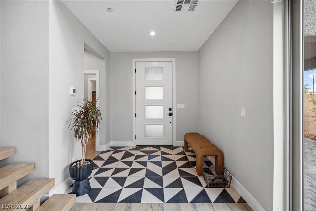 3194 Poplar Crest Court, Henderson, NV 89044 An inviting entry showcases a bold geometric tile floor leading to a contemporary front door.